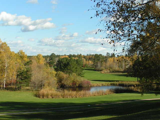 A view over a pond at A view of a green at Headwaters Golf Club