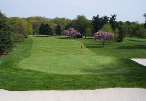 A spring view of a green guarded by bunkers at Pennsauken Country Club