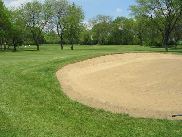 A view of a green protected by a large bunker at Bristol Oaks Golf Club and Banquet Center