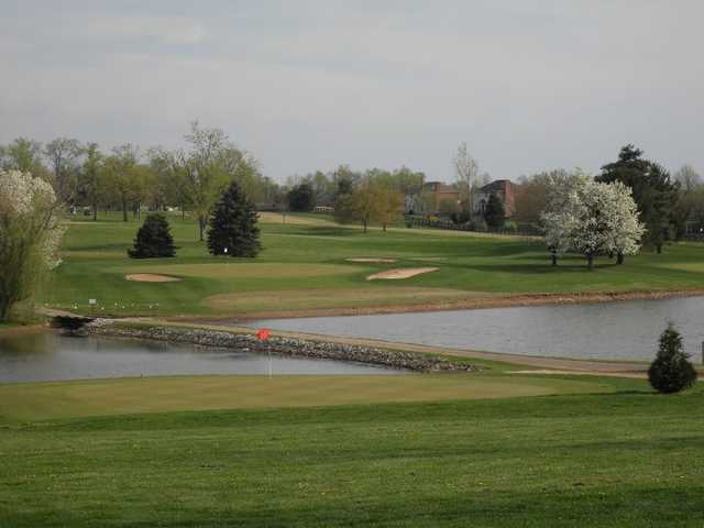 A view of a green with water coming into play at Lone Oak Golf Course