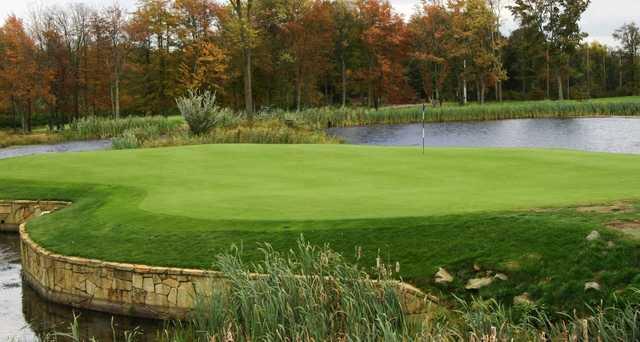 A view of a hole surrounded by water at Cranston Country Club