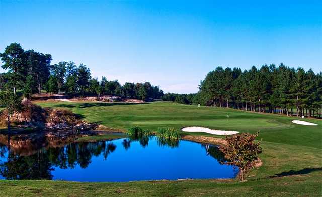 A view of a green with water and bunkers coming into play at Dogwood Hills Golf Club