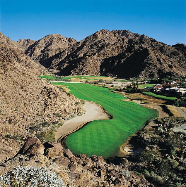 #15 on PGA WEST Pete Dye Mountain Course is laying along the base of the mountains - stay tight to the base and go for this par 5 in two. The green stays snug up against the base and will not be in full view.