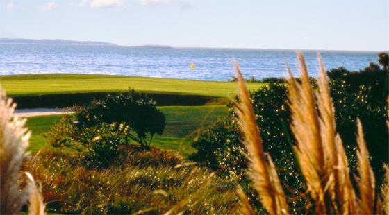 Surrounded by water and sand bunkers.