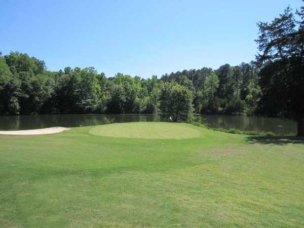 A view of the 10th green with water in background at Oconee Country Club