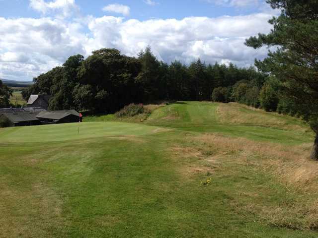 A view of a green and a fairway at Hawick Golf Club