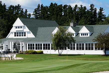 A view of a green and the clubhouse in background at Charlevoix Golf & Country Club
