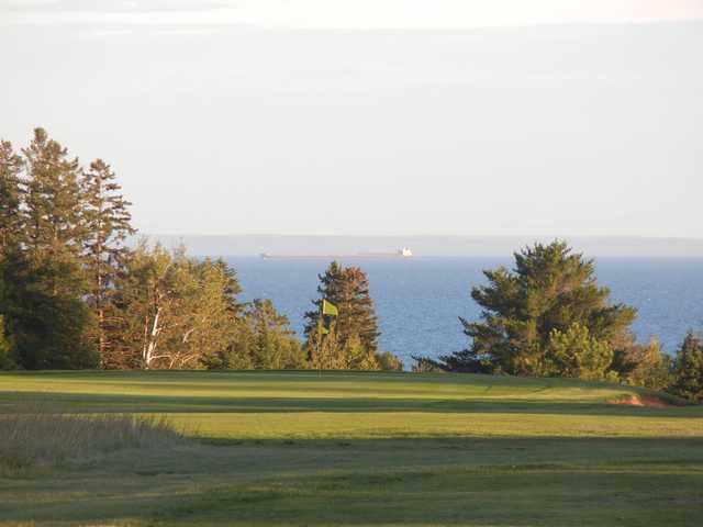 A view of a hole with water in background at Lakeview National Golf Course