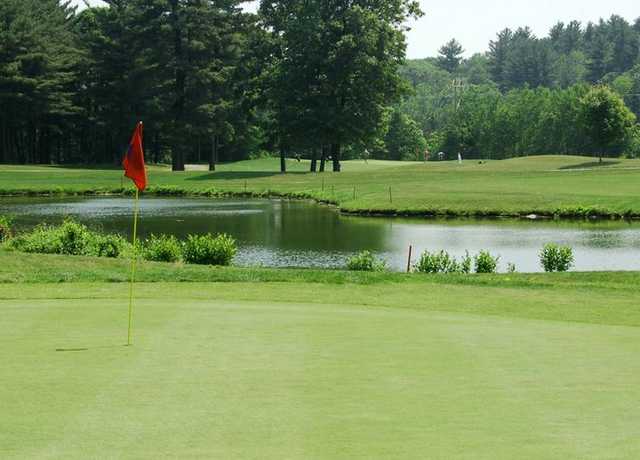 A view of a hole with water in background at Sassamon Trace Golf Course