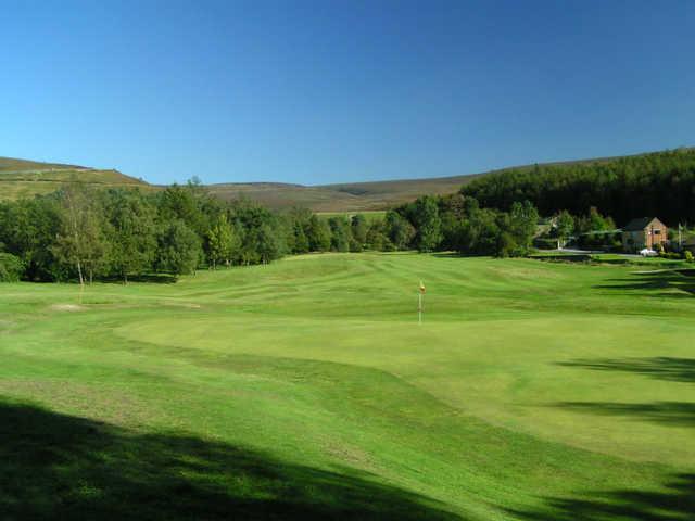 A sunny day view of a green at Glossop & District Golf Club