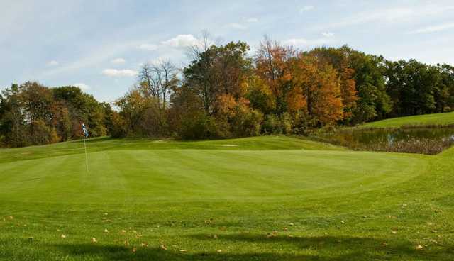 A view of a green protected by a pond at Pine Ridge Country Club