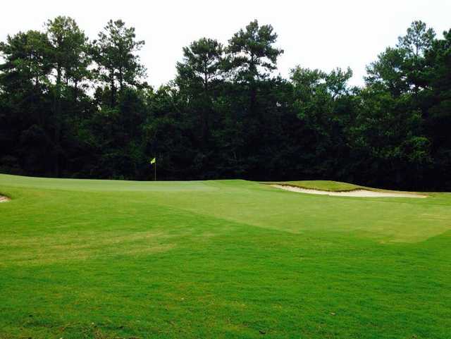 A view of a green protected by sand traps at Laurel Island Links