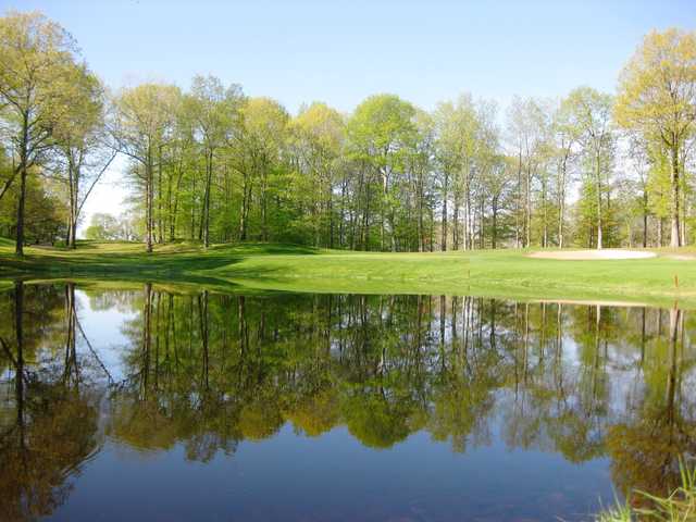 A view over the water of the 8th green at Tallwood Country Club
