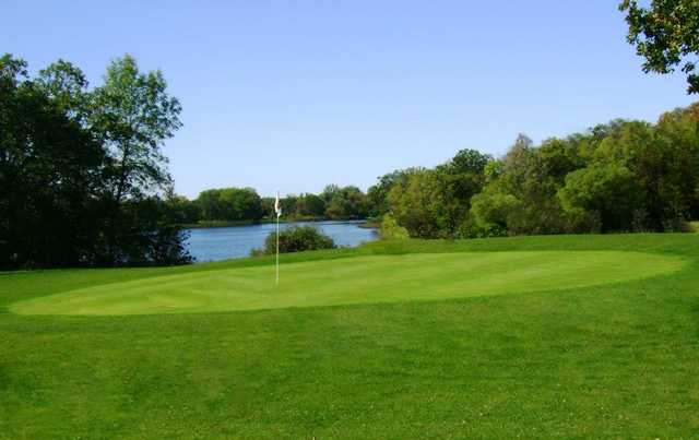 A view of a green with water in background at Hardwood Hills Golf Course