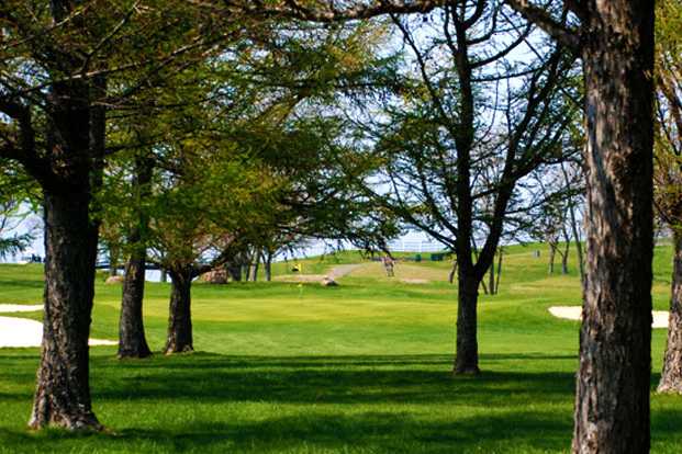 A view of a hole protected by tricky bunkers at Island's End Golf & Country Club