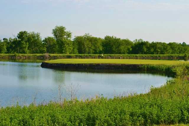 A view of a green surrounded by water at Hoot's Hollow at Country Creek Golf Club