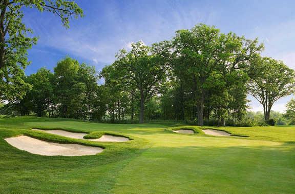 A view of a green guarded by bunkers at Cantigny Golf