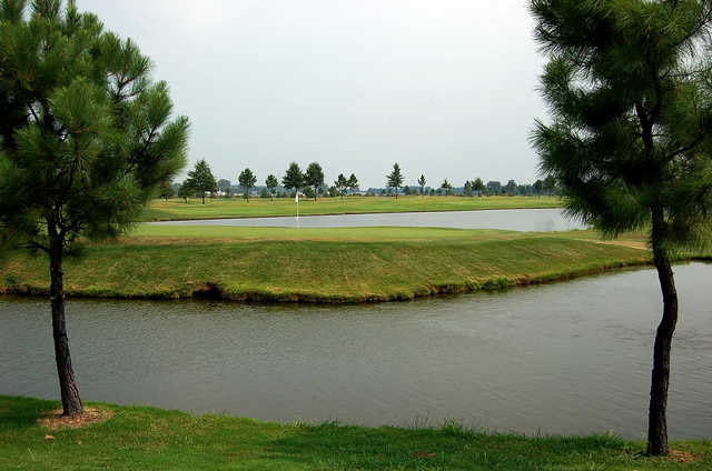 A view of a hole surrounded by water at Marion Lakes Golf & Athletic Club.