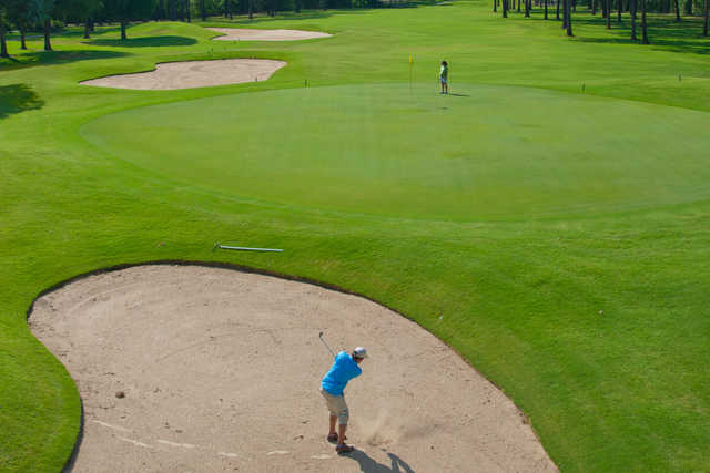 A view of a hole surrounded by bunkers at Twin Lakes Golf Course