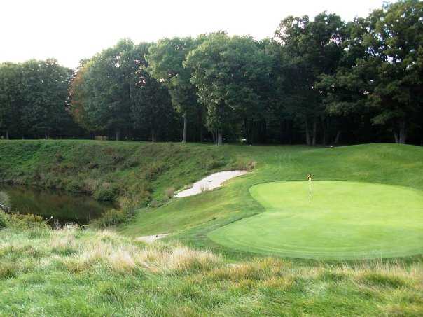 A view of the 17th hole surrounded by water at Pohlcat Golf Course