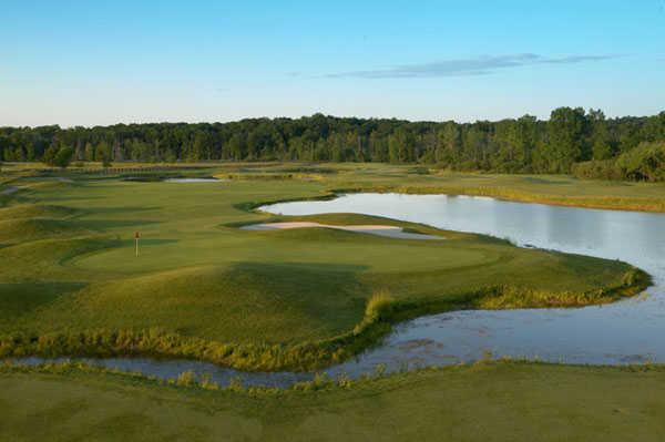 A view of a green surrounded by water at Devil's Ridge Golf Club