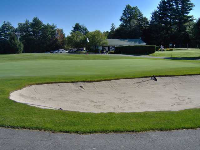 A view of a green protected by a large tricky bunker at Copley Country Club