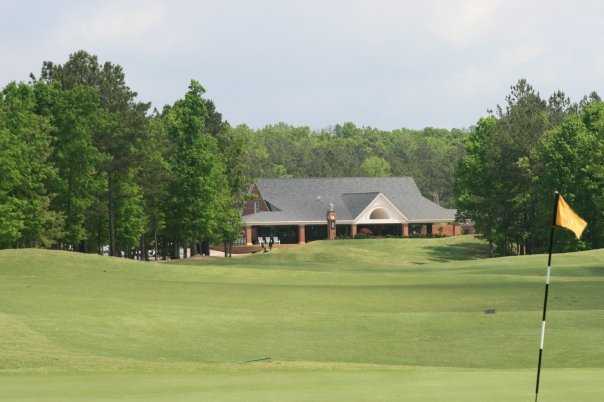 A view of a green with the clubhouse in background at Lion Golf Club