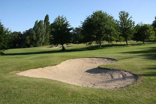 A view over a heart shaped bunker at Anjou Golf & Country Club