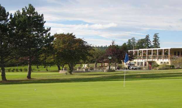 A view of a hole and the clubhouse in background at Salt Spring Island Golf and Country Club