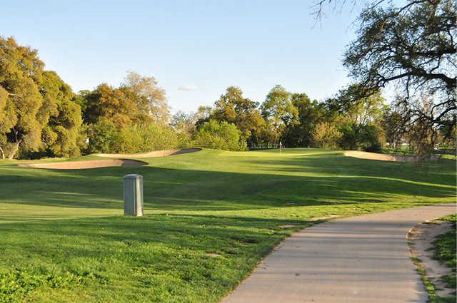 A view of a hole flanked by tricky sand traps at Haggin Oaks Golf Course