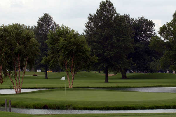 A view of a green surrounded by water at Inwood Golf Course