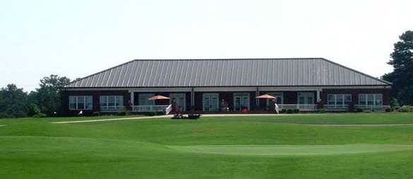 A view of a green with the pro shop in background at Southern Hills Golf Club.