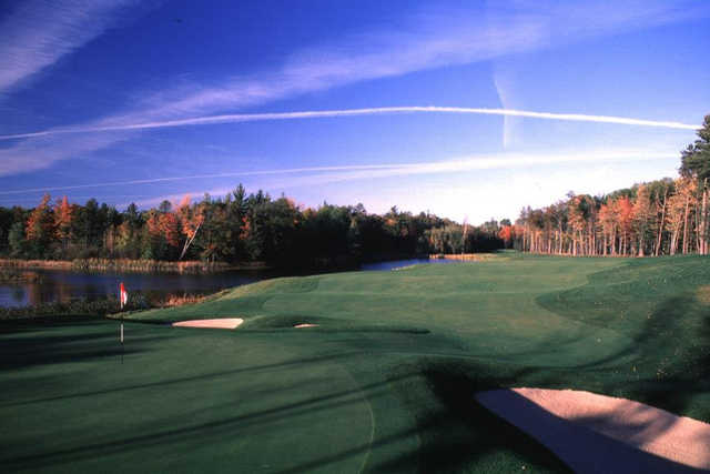 A view of a green with water and bunkers coming into play at Black Lake Golf Club