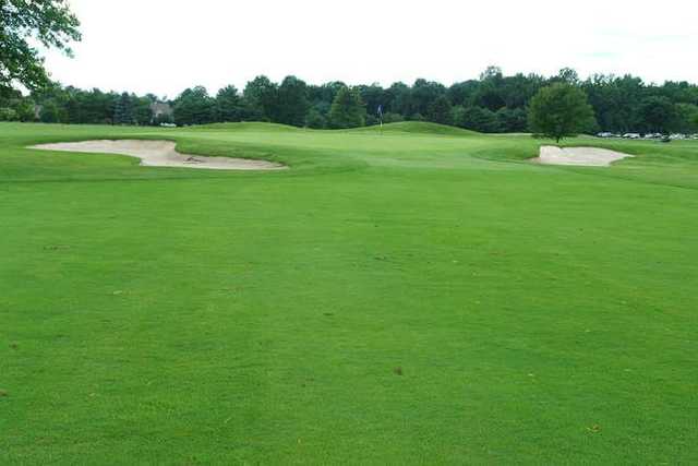 A view of green #5 flanked by sand traps at Maple Dale Country Club