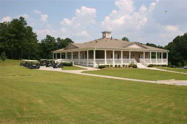 A view of the clubhouse and golf carts at Collins Hill Golf Club
