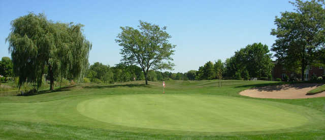 A view of a green protected by a bunker at Millcroft Golf Club.