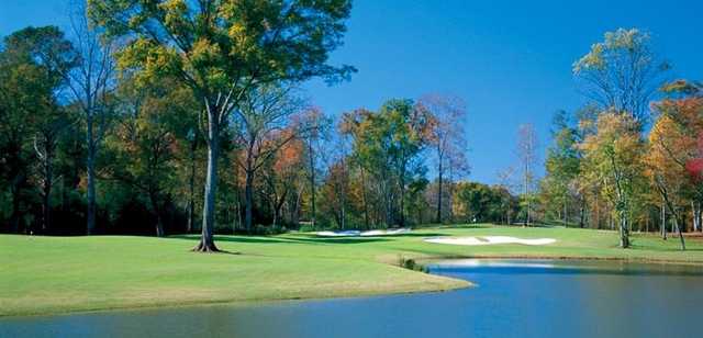 A view of a green protected by fall coloured trees at Chancellors from Georgia Club