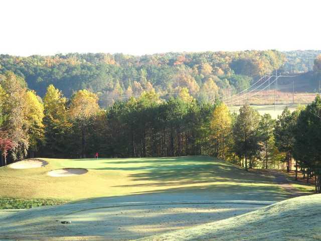 A fall view of a green protected by bynkers at Callahan Golf Links