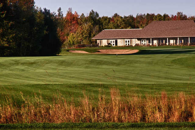 A view of a fairway and the clubhouse in the distance at GreyHawk Golf Club