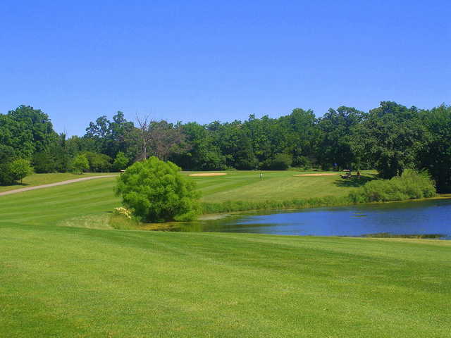 A view of a green surrounded by water at Brighton Dale Links