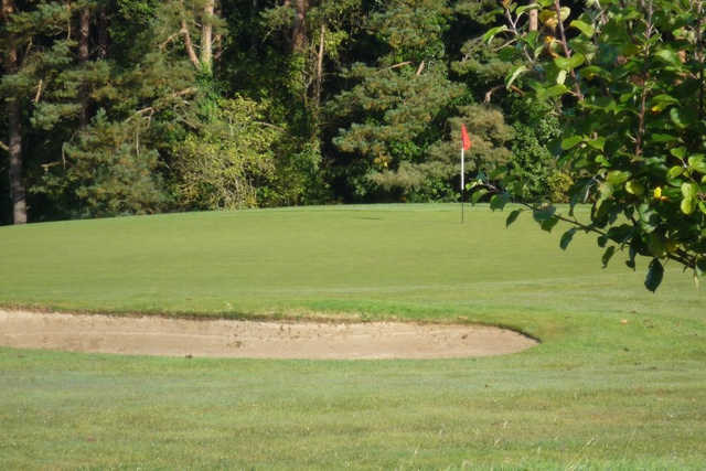 A view of a green protected by a sand trap at Loughgall Golf Club