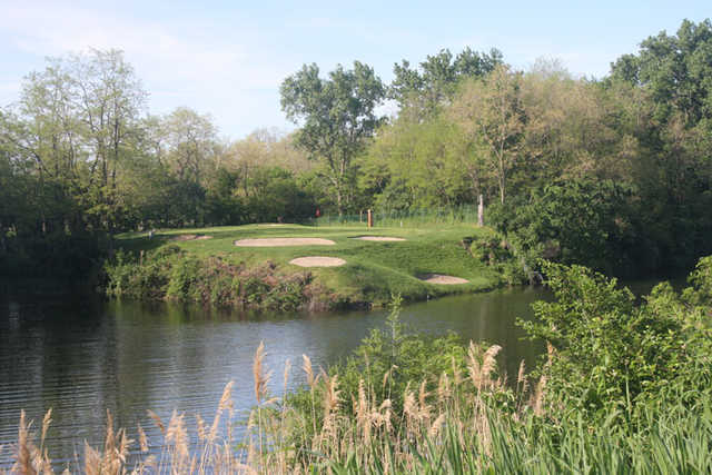 A view over the water of green #16 at Cinder Ridge Golf Course
