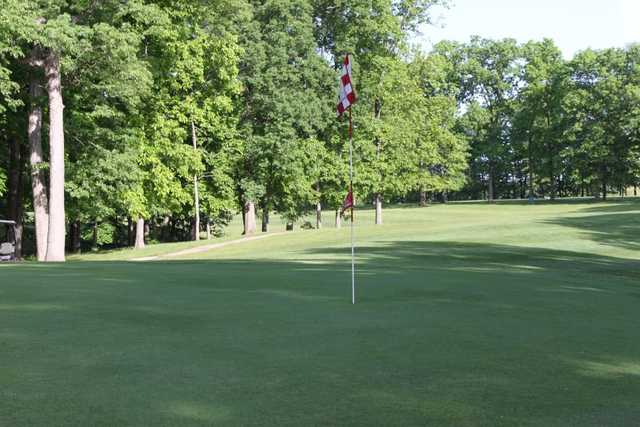 A sunny day view of a hole at Arrowhead Heights Golf Course