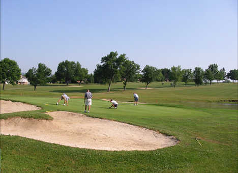 A view of a green protected by bunkers at Maplehurst Country Club