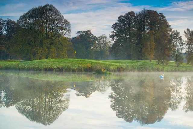 A view over the water of a green at Galgorm Castle Golf Club