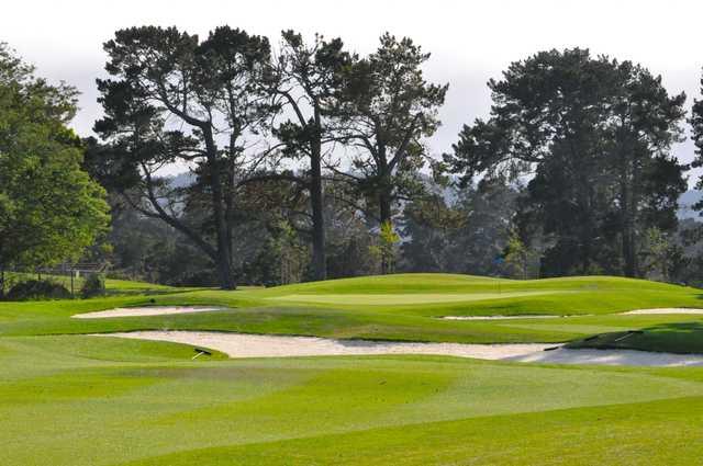 A view of a green protected by bunkers at Monterey Pines Golf Club