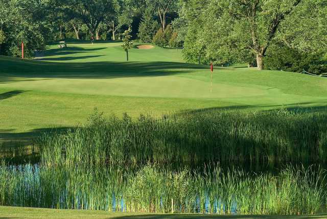 View of a green and pond at Bartlett Hills Golf Club