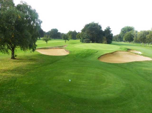 The raised 14th green at Oxley Park Golf Club with surrounding sandtraps