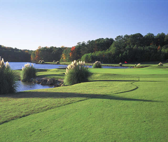 View of a green and lake at Stone Mountain Golf Course