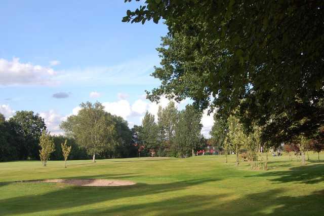 View from the trees of the 6th hole and bunker at Woolton Golf Club